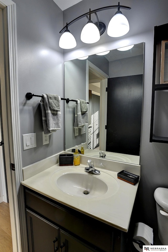 bathroom featuring vanity and toilet