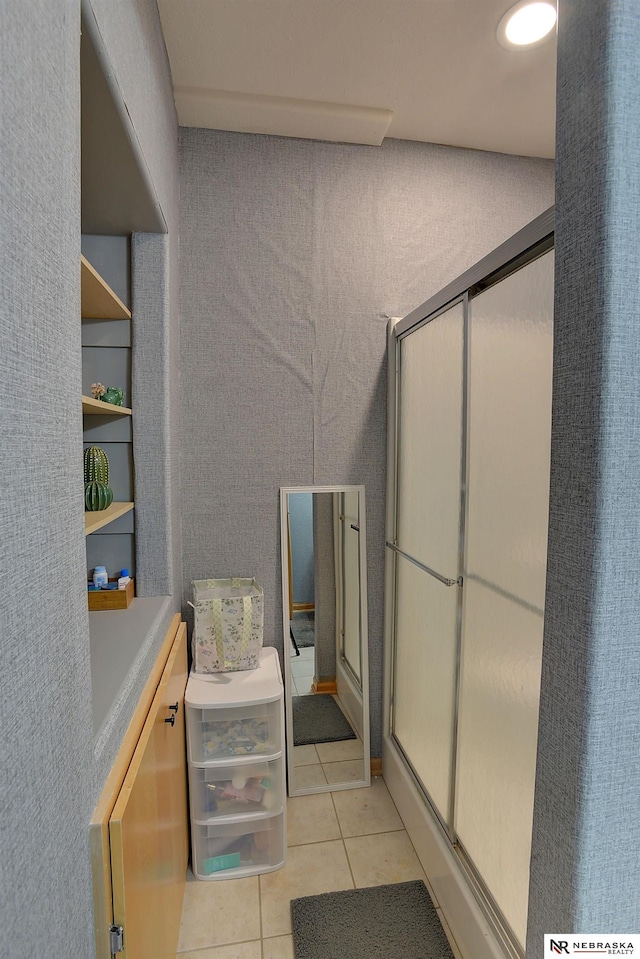 bathroom featuring tile patterned flooring and an enclosed shower