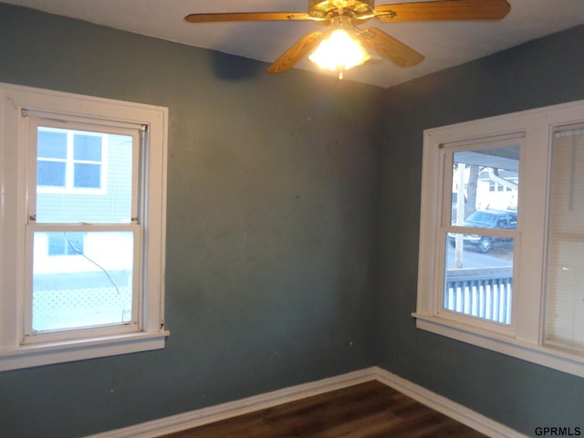 unfurnished room with ceiling fan, plenty of natural light, and hardwood / wood-style flooring