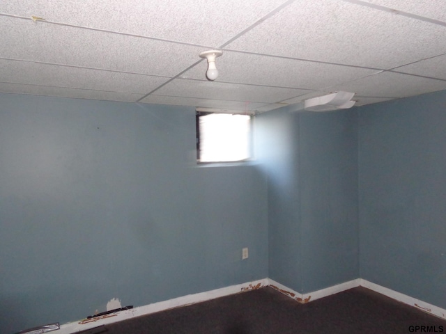 carpeted spare room with a paneled ceiling