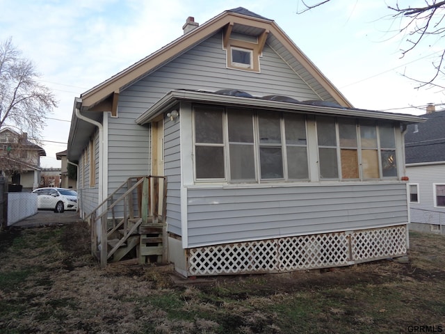 view of side of home with a sunroom