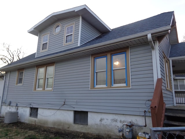 view of side of property featuring central air condition unit