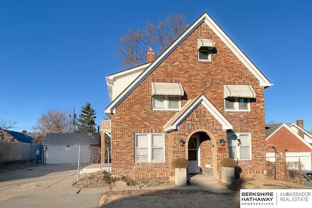 front of property featuring a garage and an outbuilding