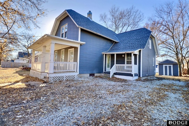 view of front of home featuring covered porch and a storage shed