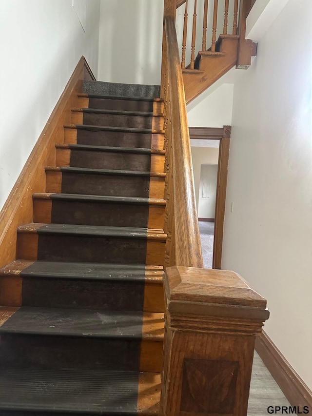 stairway with hardwood / wood-style flooring