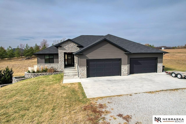 view of front of property with a garage and a front lawn