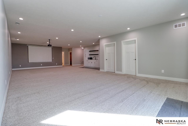 unfurnished living room with light carpet