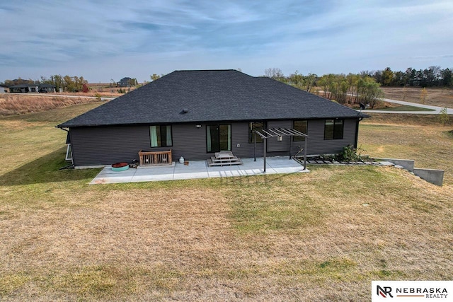 back of house featuring a lawn and a patio area