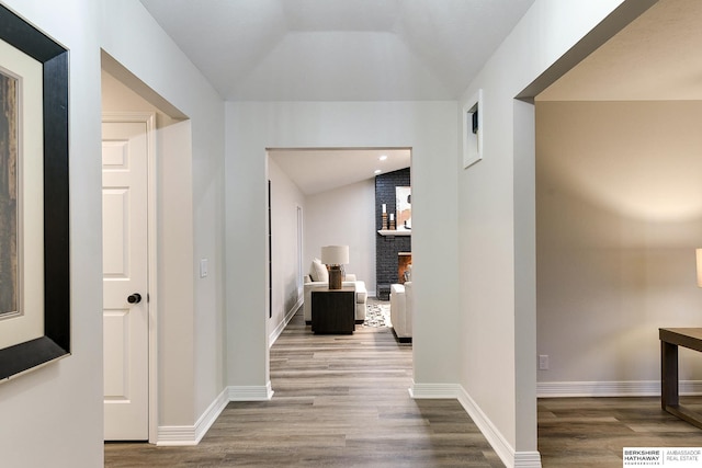 hall featuring hardwood / wood-style floors and lofted ceiling