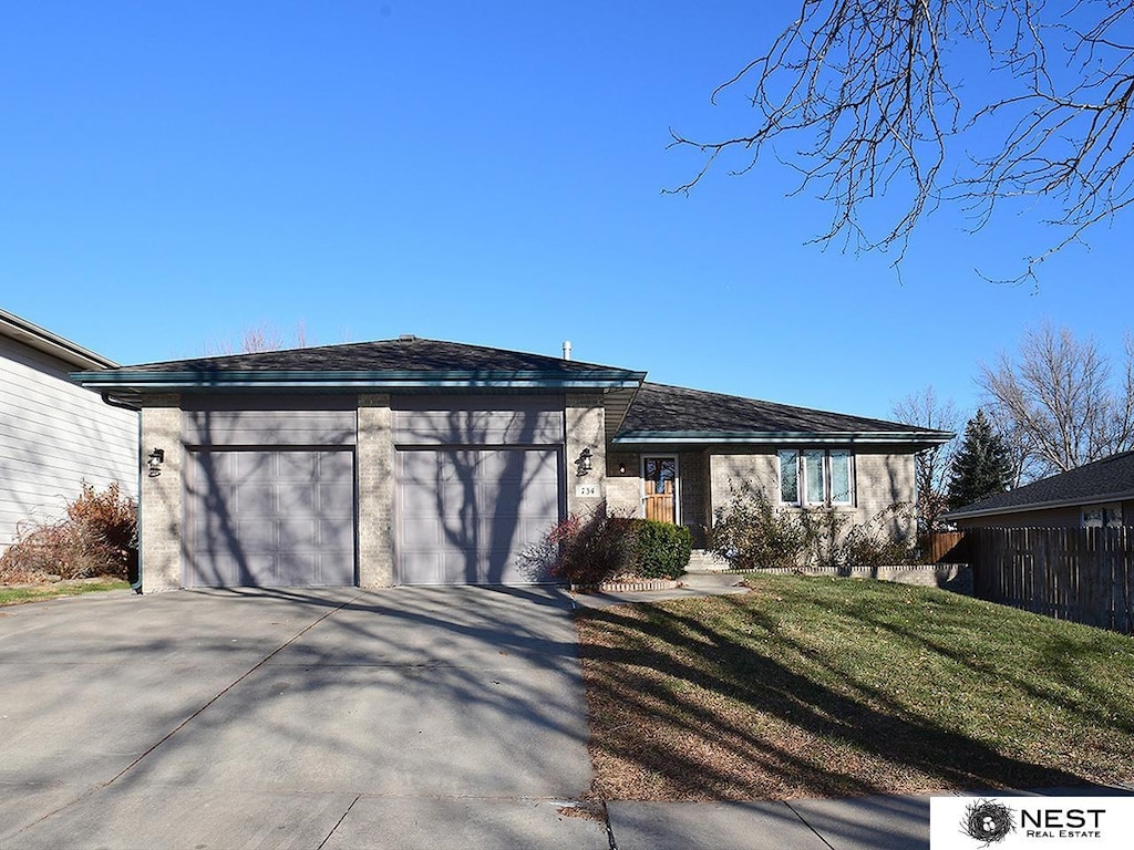 view of front of home featuring a garage and a front lawn