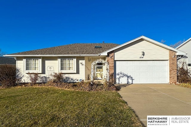 ranch-style house featuring a front yard and a garage