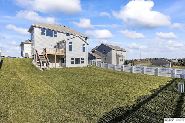 back of house featuring a deck and a yard