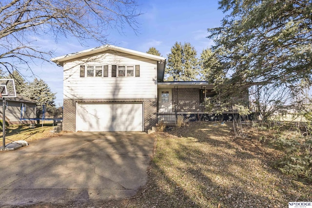 view of front of house with a garage and a trampoline