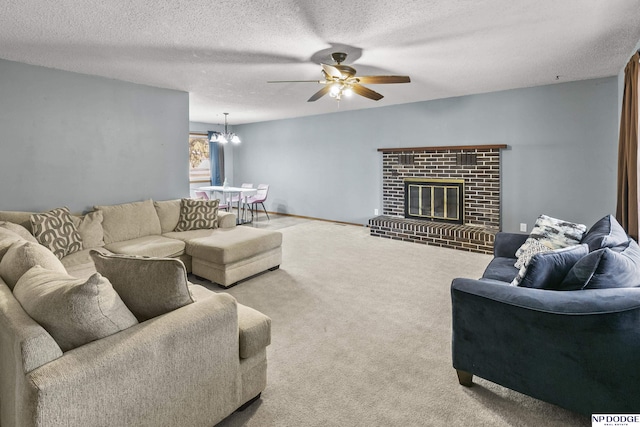 living room with ceiling fan with notable chandelier, a fireplace, carpet floors, and a textured ceiling