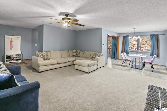 carpeted living room featuring ceiling fan with notable chandelier and a textured ceiling