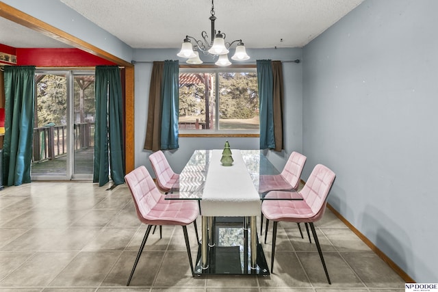 dining room featuring a chandelier and a textured ceiling