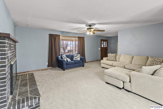 carpeted living room featuring a textured ceiling, a brick fireplace, and ceiling fan