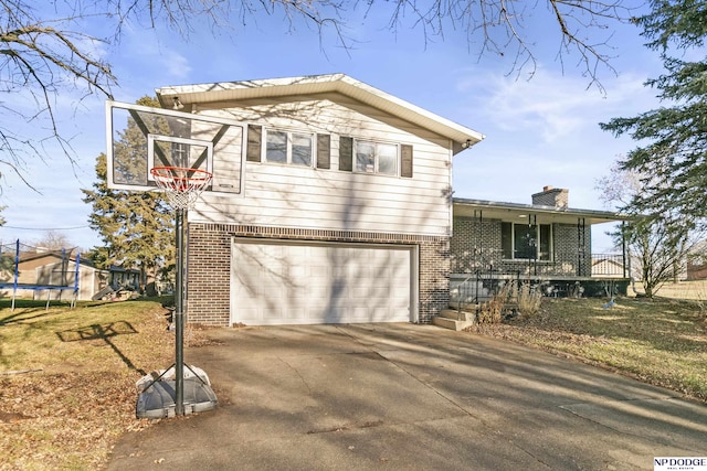 view of front facade with a garage, a trampoline, and a front lawn