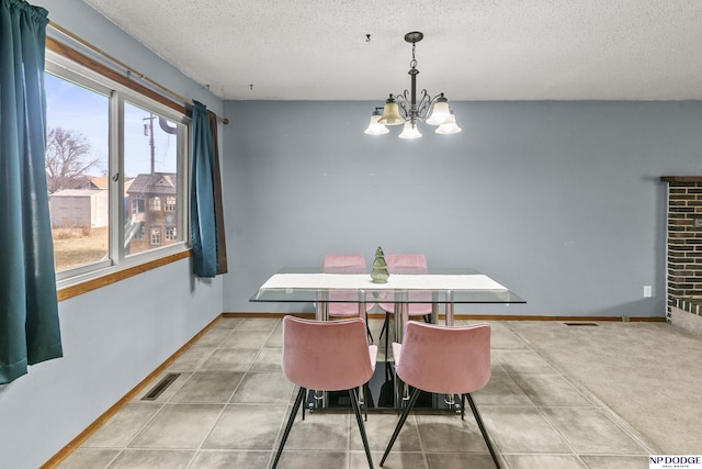 dining area with a textured ceiling, light carpet, and an inviting chandelier