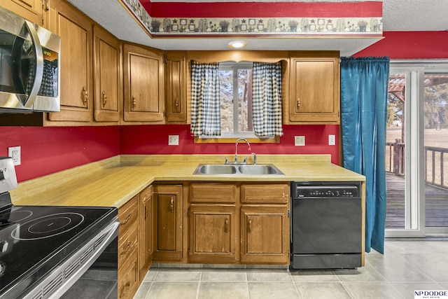 kitchen featuring electric range oven, a textured ceiling, sink, light tile patterned floors, and dishwasher