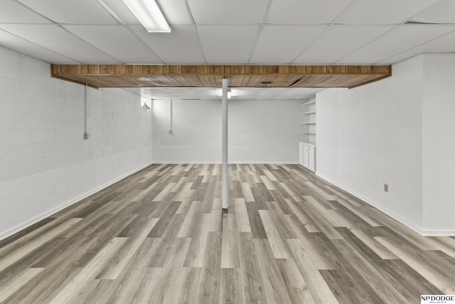 basement with hardwood / wood-style flooring