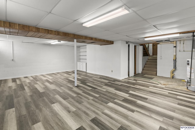 basement with hardwood / wood-style floors and gas water heater