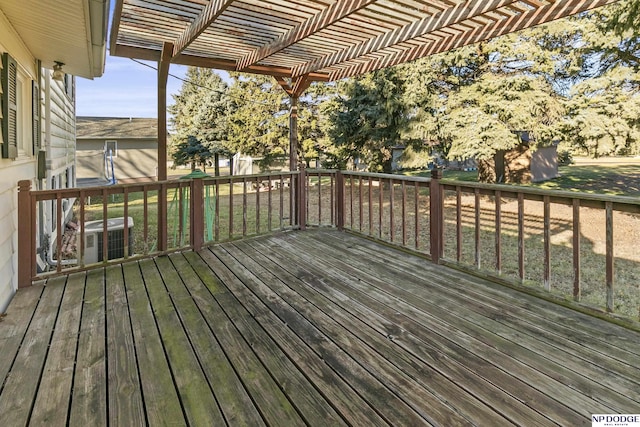 wooden terrace with a lawn, a pergola, and central AC