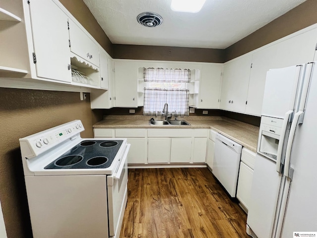 kitchen featuring sink, white cabinets, dark wood-type flooring, and white appliances