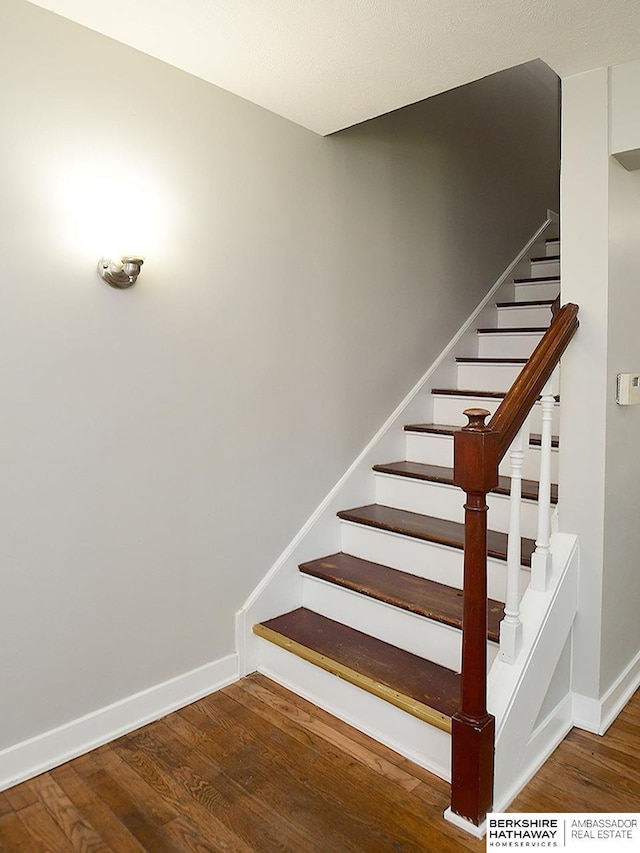 stairs featuring hardwood / wood-style flooring