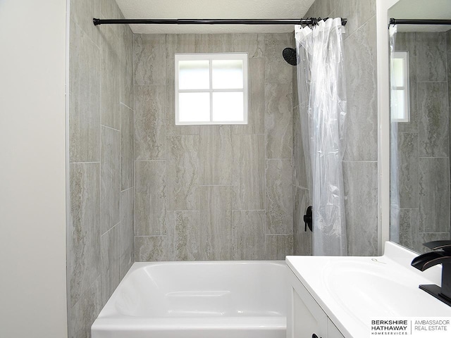 bathroom with shower / bath combo and vanity