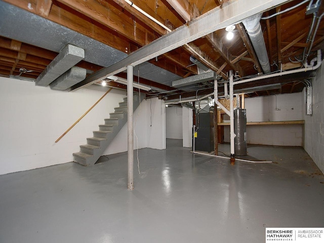 basement featuring heating unit and water heater