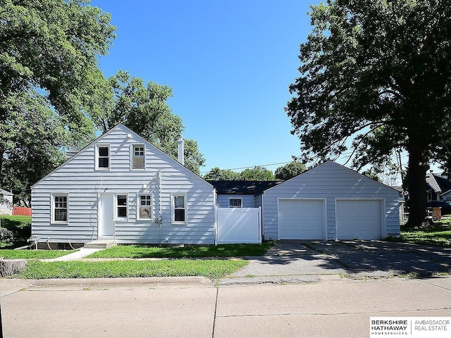 view of front facade featuring an outbuilding and a garage