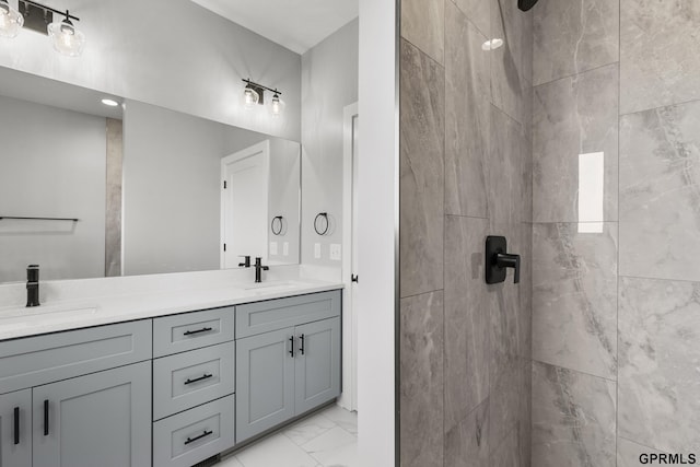 bathroom featuring vanity and tiled shower