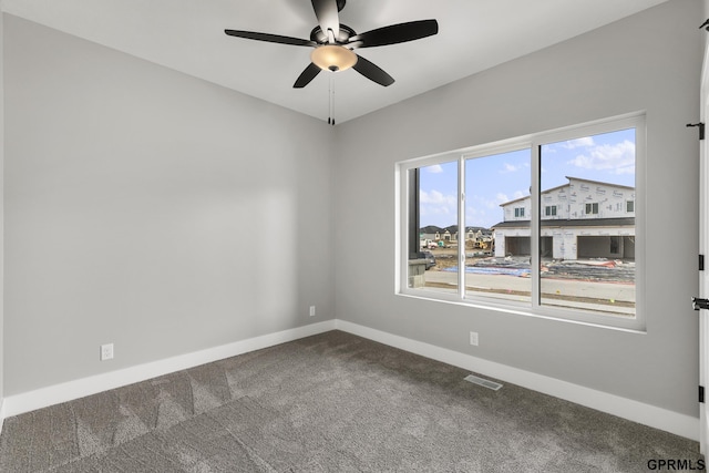 carpeted spare room with ceiling fan