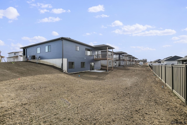 rear view of property featuring central AC