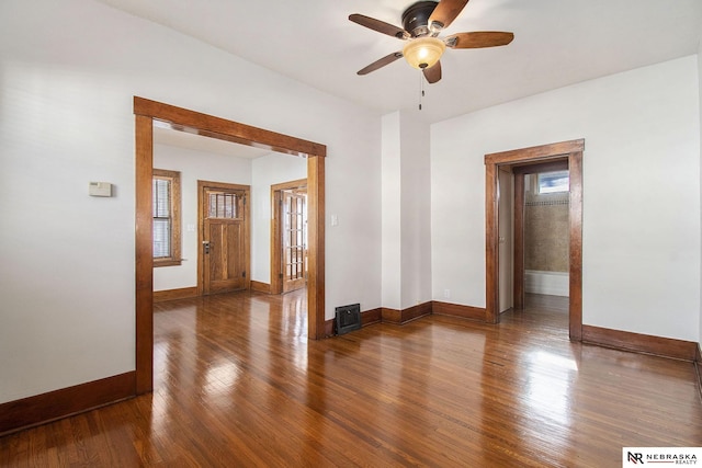 spare room featuring dark hardwood / wood-style flooring and ceiling fan