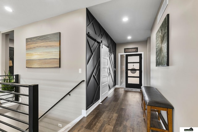 entrance foyer featuring dark hardwood / wood-style flooring and a barn door