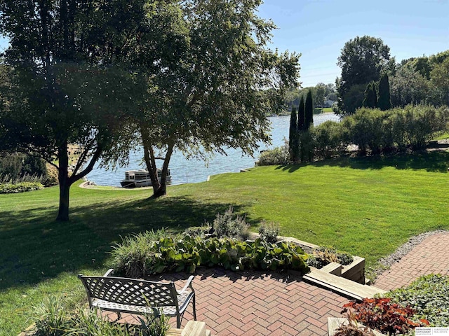 view of yard with a water view and a patio