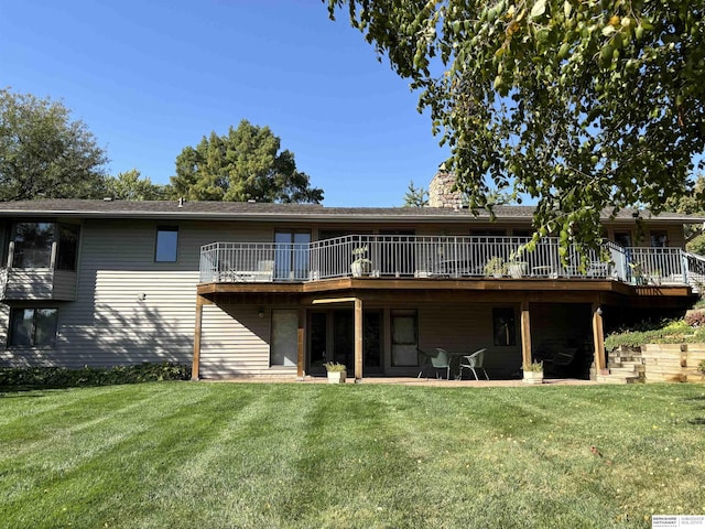 rear view of house featuring a lawn