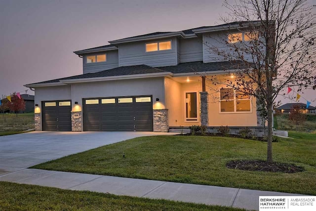 prairie-style home with a lawn and a garage