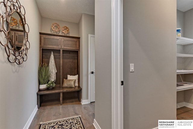 mudroom with light hardwood / wood-style flooring and a textured ceiling