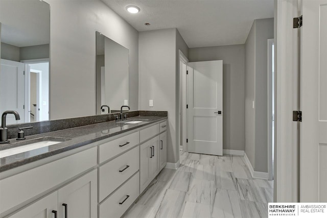 bathroom featuring a textured ceiling and vanity