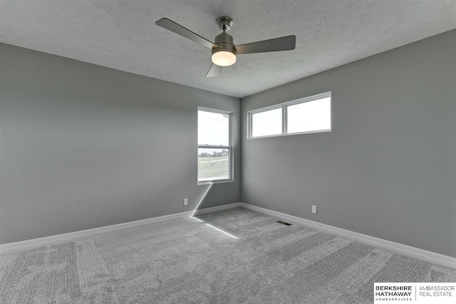 spare room with ceiling fan, carpet floors, and a textured ceiling