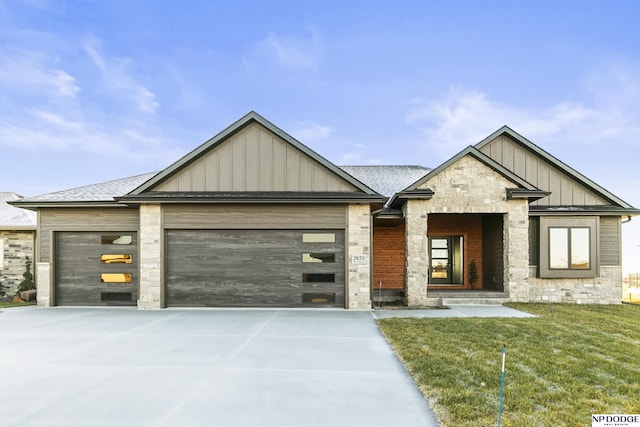 view of front of house with a garage and a front lawn