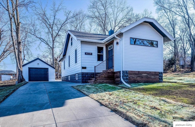 view of front of house with a front yard, a garage, and an outdoor structure