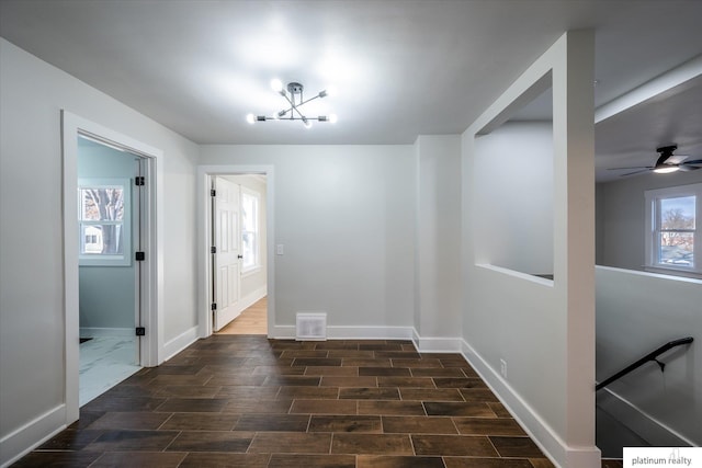 interior space featuring a notable chandelier and dark wood-type flooring