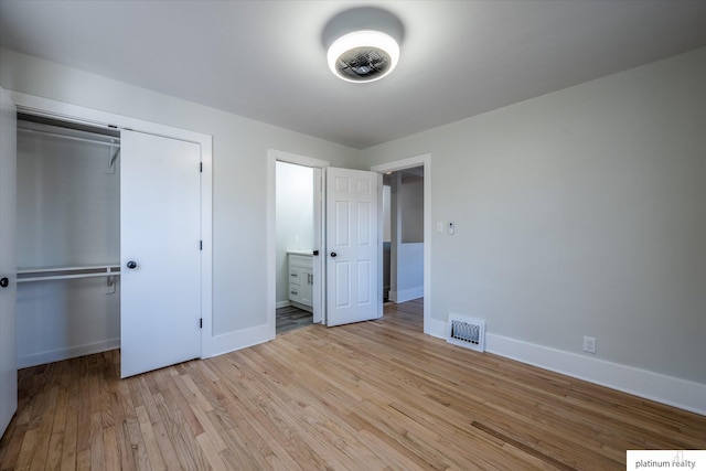 unfurnished bedroom featuring light hardwood / wood-style flooring and a closet