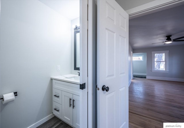 bathroom featuring vanity, hardwood / wood-style flooring, and ceiling fan