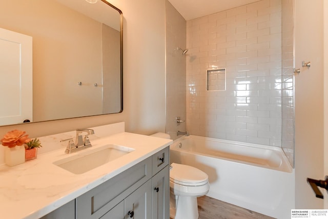 full bathroom with wood-type flooring, vanity, toilet, and tiled shower / bath