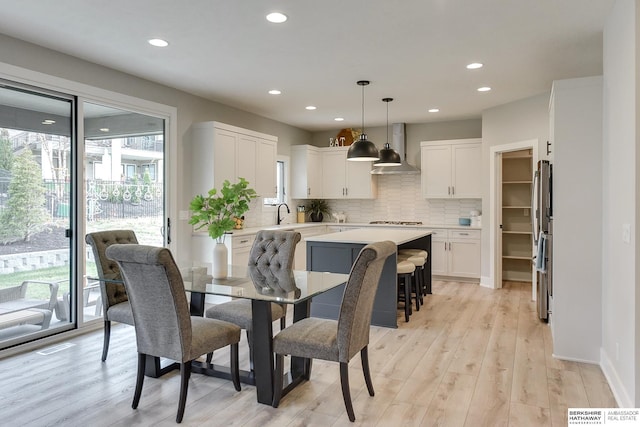 dining space with light wood-type flooring